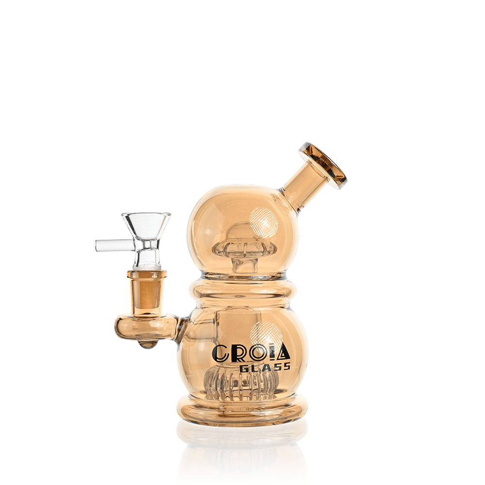 Front-facing shot of the Croia Glass 6" Mini Egg Dab Rig with Crown Perc | Croia Glass in amber glass showing its double-bubbled body, angled mouthpiece, and visible crown percolator.