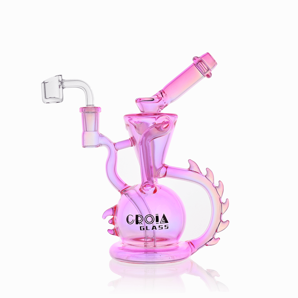 Angled front view of the pink Croia Glass 10" Dragon Spine Recycler Dab Rig showing its spherical chamber, curved spine-like handle, and tilted mouthpiece.