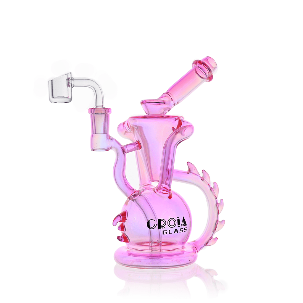 Three-quarter view of the pink Croia Glass 10" Dragon Spine Recycler Dab Rig | Croia Glass showing its curved dragon-spine handle, spherical base with logo, and angled mouthpiece.