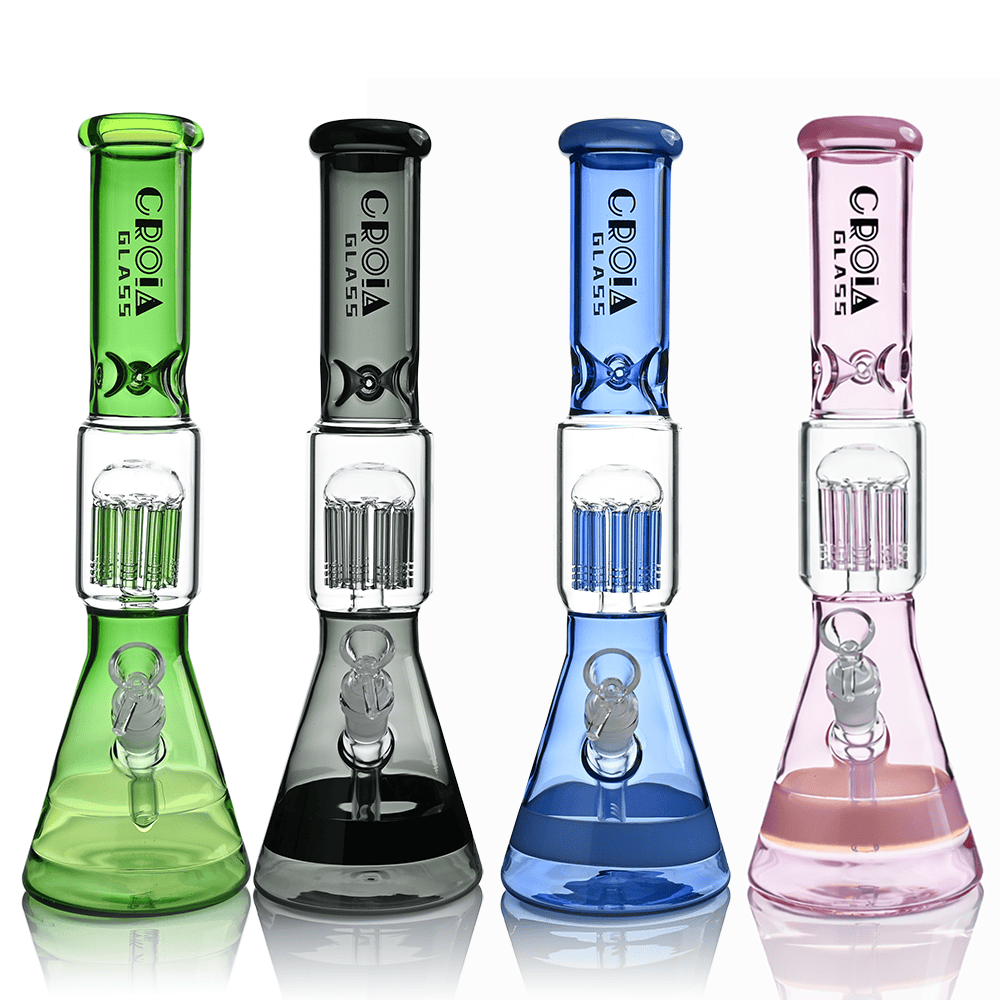 Row of four Croia Glass 15" Beaker Bong with Tree Perc and Ice Catcher | Croia Glass in green, smoke, blue, and pink shown front-on on a white background.