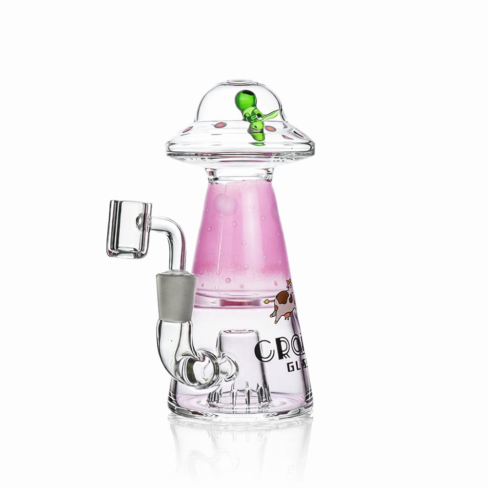 Studio-lit front view of the Croia Glass UFO Alien Dab Rig with Showerhead Perc showcasing a pink cone body, clear UFO top and small green alien detail.