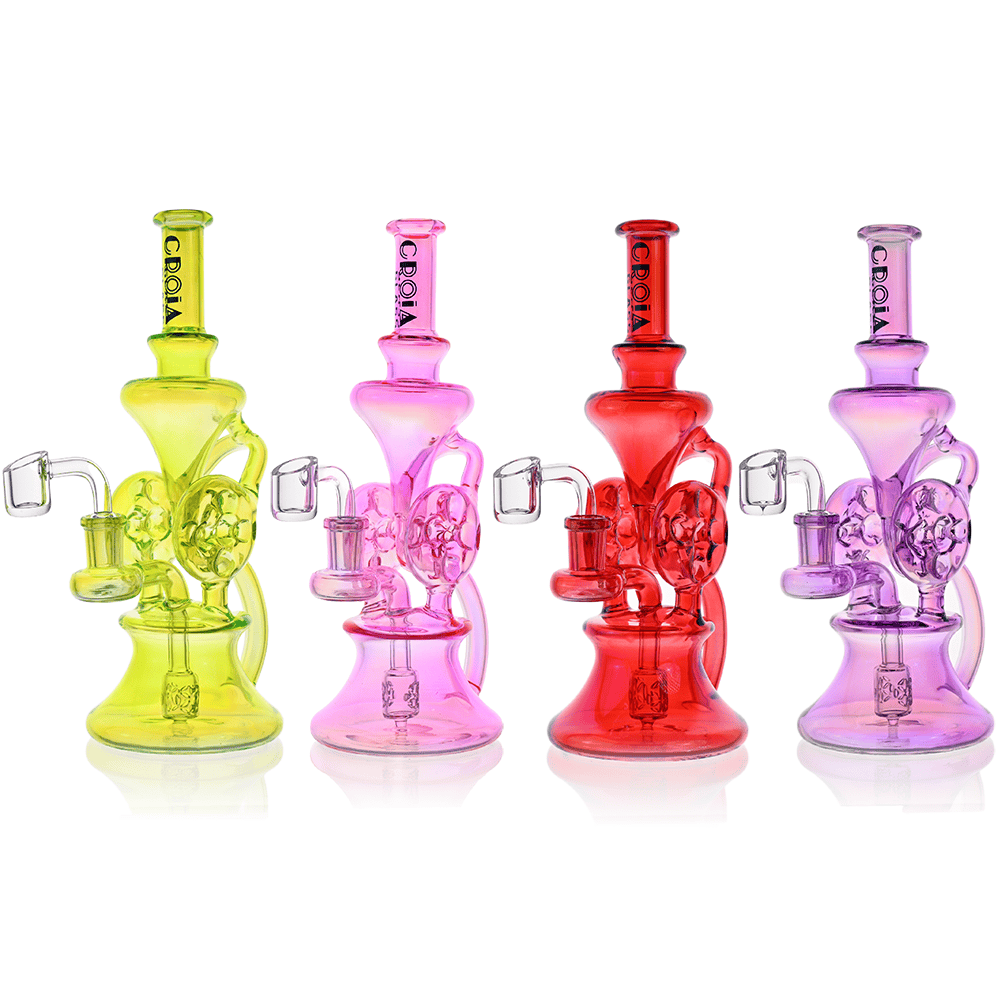 Row of four colorful Croia Glass 10" Dual Swiss Perc Klein Recycler Dab Rig | Croia Glass pieces (lime, pink, red, purple) on white.