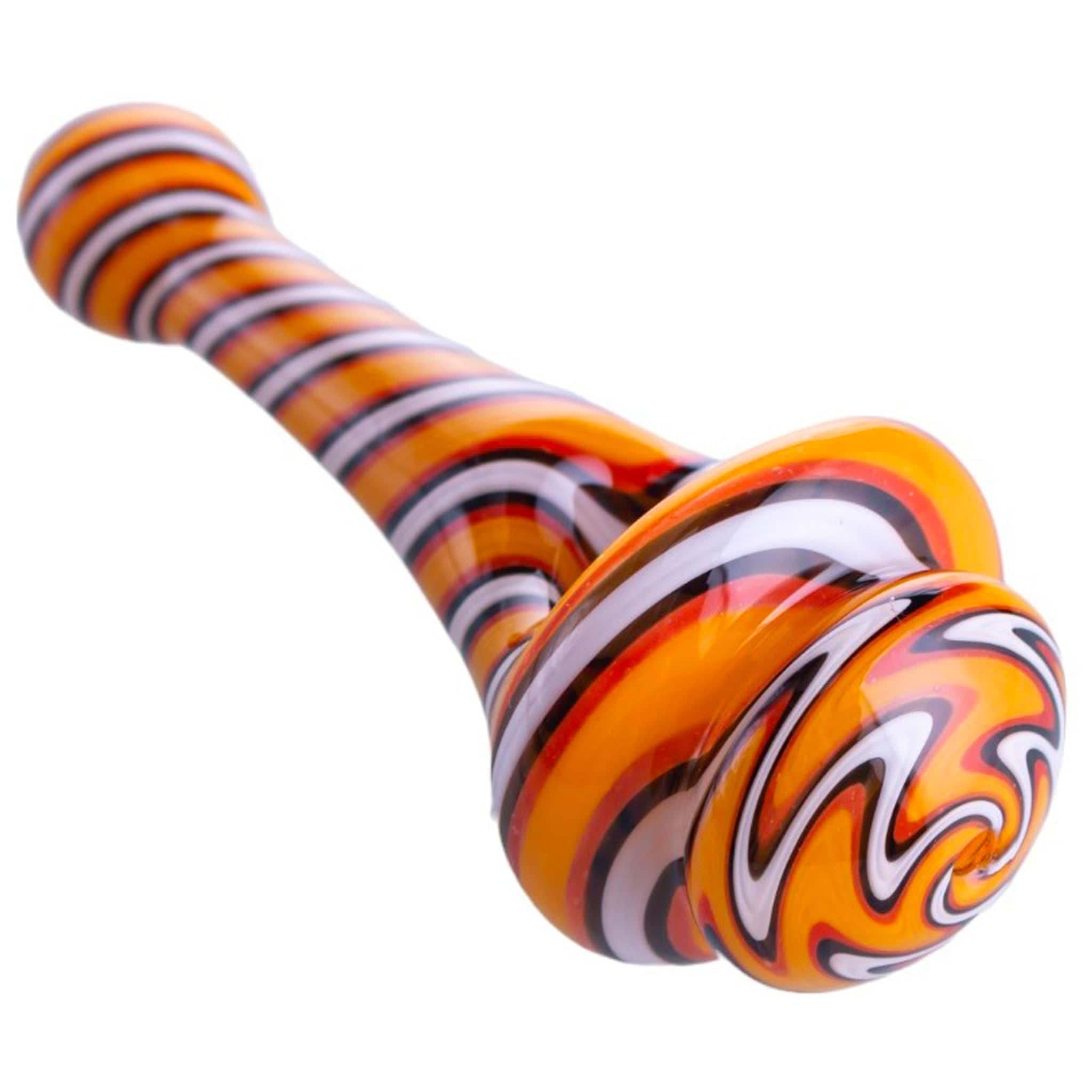 Angled close-up of the Maize Spinning Top Pipes showing orange and black spiral stripes on a glossy curved glass surface.