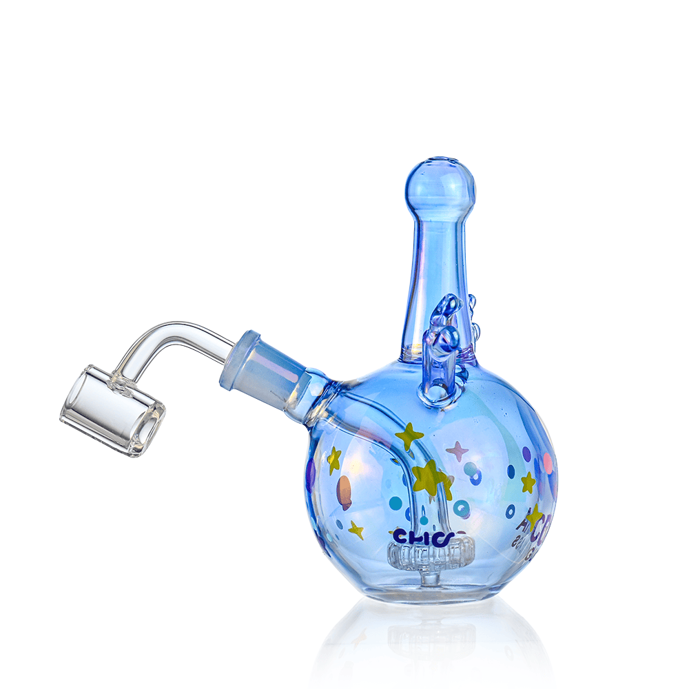 Angled studio shot of the Croia Glass Cyclops Monster Mini Dab Rig with Showerhead Perc, a blue glass orb decorated with stars.