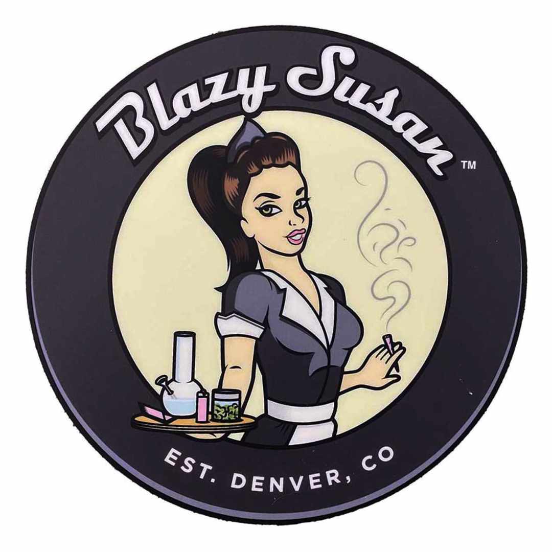 Top-down view of a circular 8" Blazy Susan 8" Silicone Tray Mat showing a retro waitress holding a tray with a bong, jar, and lighter against a pale center and dark outer ring.