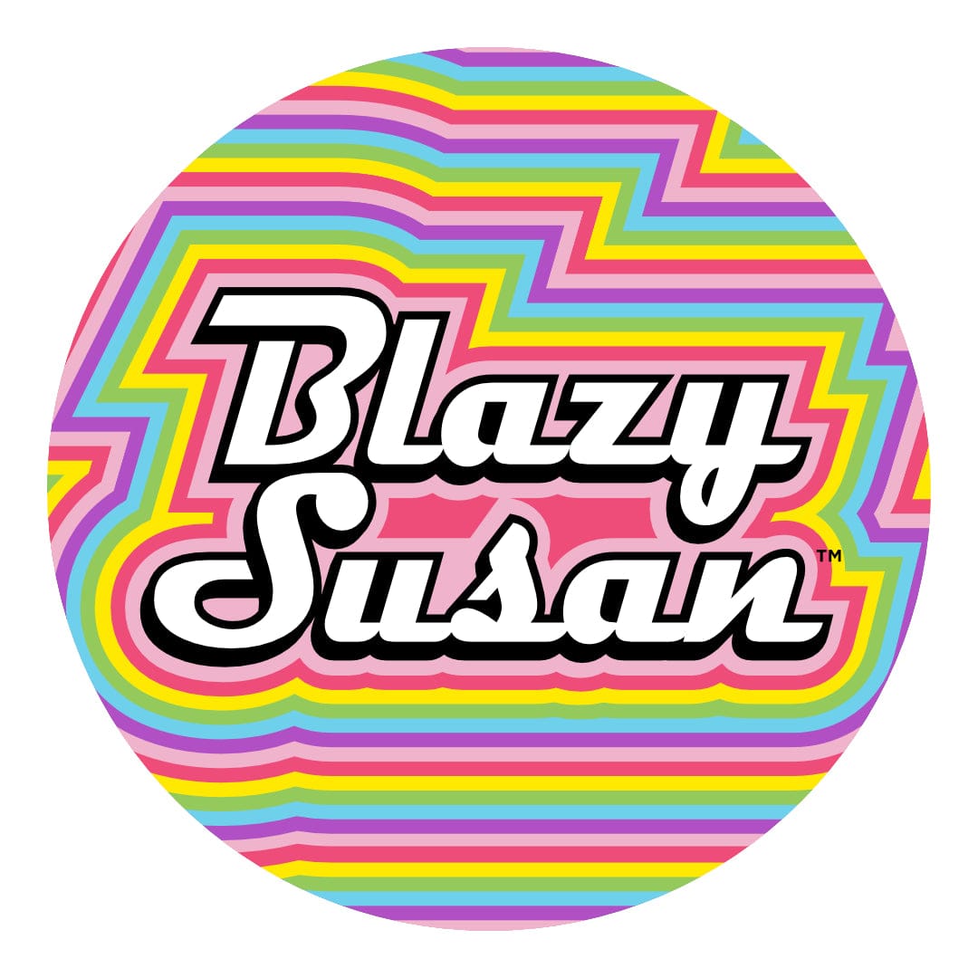 Top-down view of the Blazy Susan 8" Silicone Tray Mat showing a round, Vaporwave-style design with layered rainbow zigzag stripes and bold white "Blazy Susan" lettering.