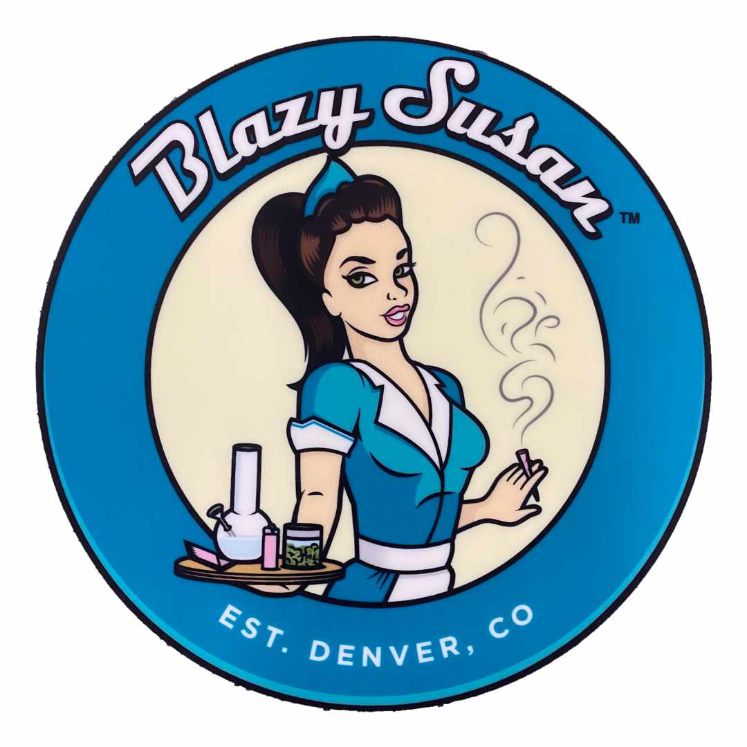 Top-down view of the circular logo mat showing a retro waitress illustration with smoke and paraphernalia, labeled "Blazy Susan 8" Silicone Tray Mat".