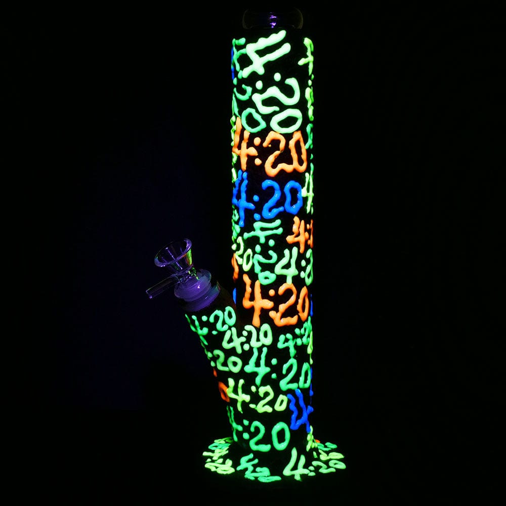 Front view of the “It’s 420 Everywhere” glow-in-the-dark straight tube water pipe, illuminated against a black background.