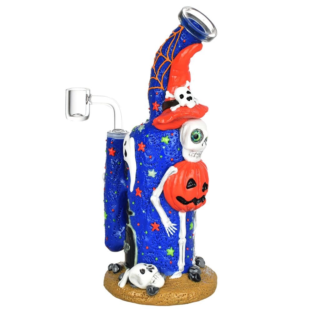 A three-quarter view of the Frightening Fiesta Enamel on Glass Dab Rig, with vibrant enamel designs on a glass base and a matching mouthpiece.