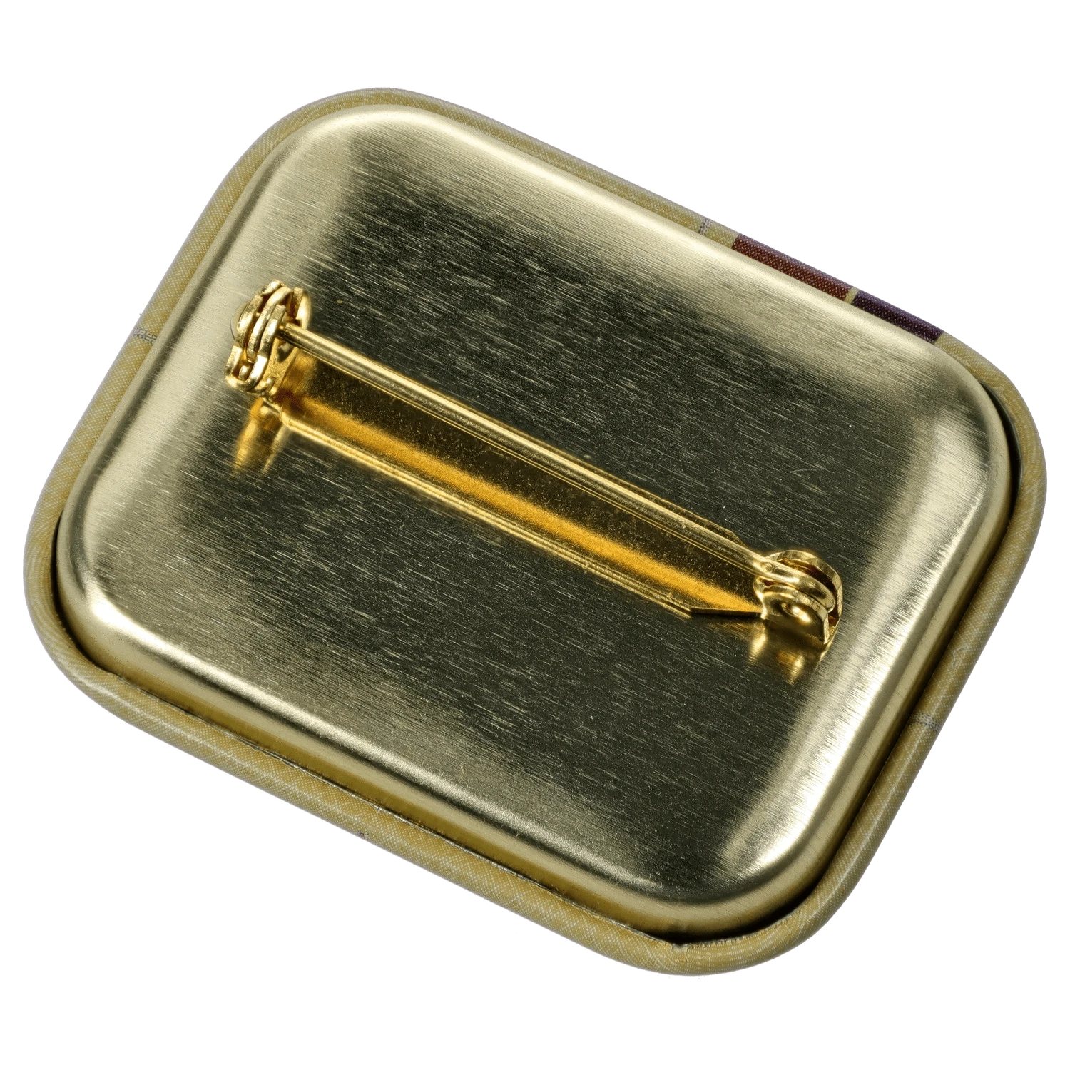 Angled close-up of the gold metal backing and pin of the DHC x RAW Chronic Collab Smoking Box, showing brushed texture and rounded corners