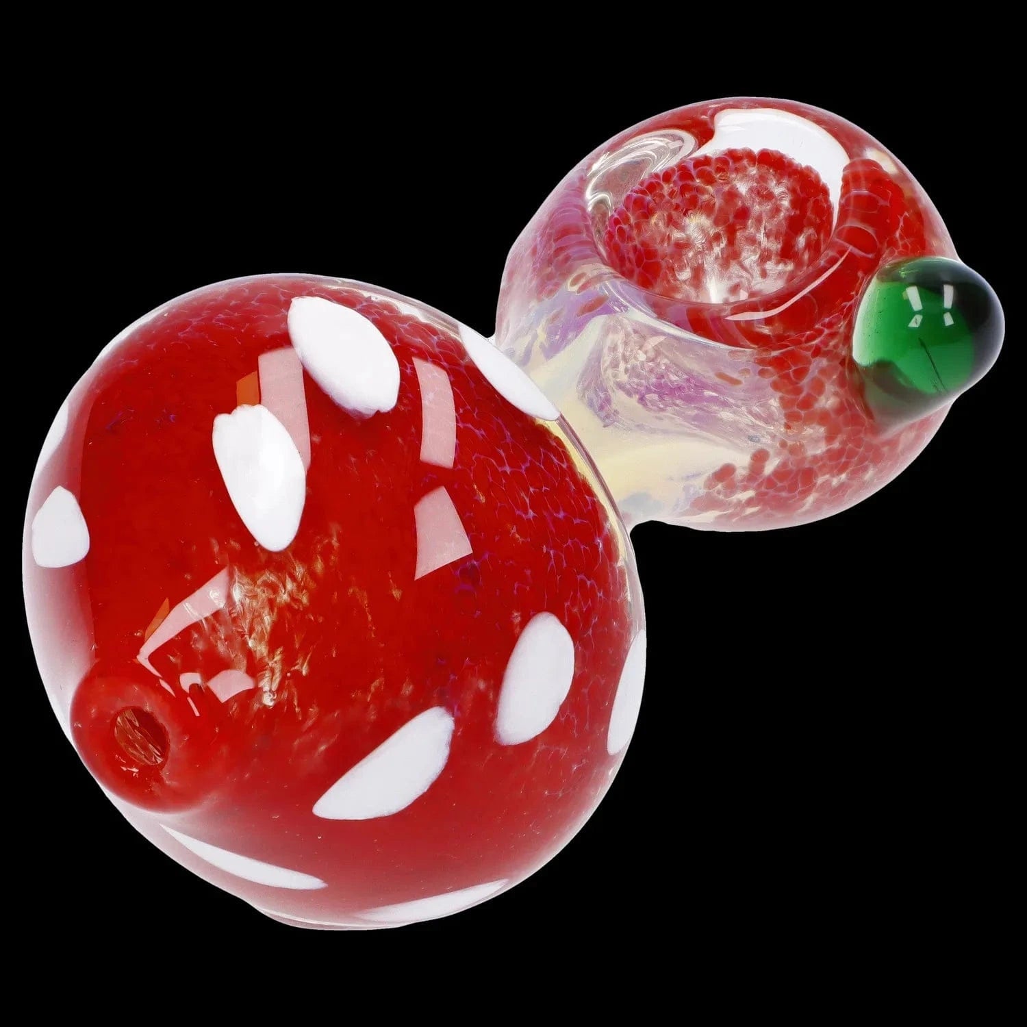 Close-up angled view of the Mushroom Frit Spoon Pipe - 4.5 in showing its glossy red mushroom-shaped bowl with white spots and a green glass accent against a black background.