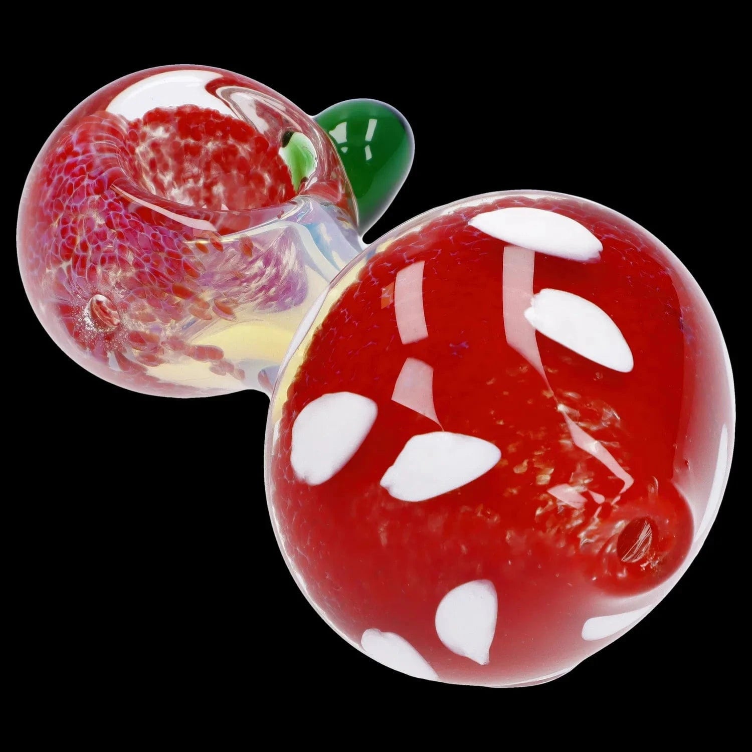 Close-up angled view of the Mushroom Frit Spoon Pipe - 4.5 in showing its glossy red mushroom cap with white spots and a textured clear bowl against a black background
