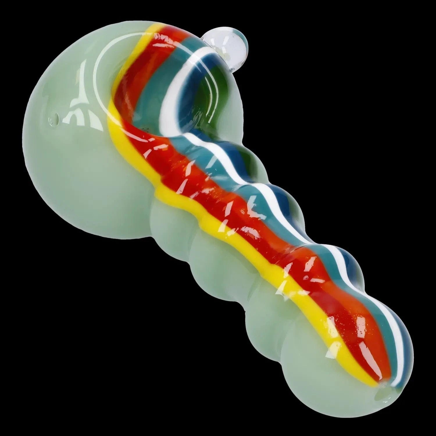 Angled close-up of the Slime Rasta Rainbow Spoon Pipe - 4.5 in showing its pale green glass body with raised bubble contours and a glossy red, yellow and blue rainbow stripe down the center