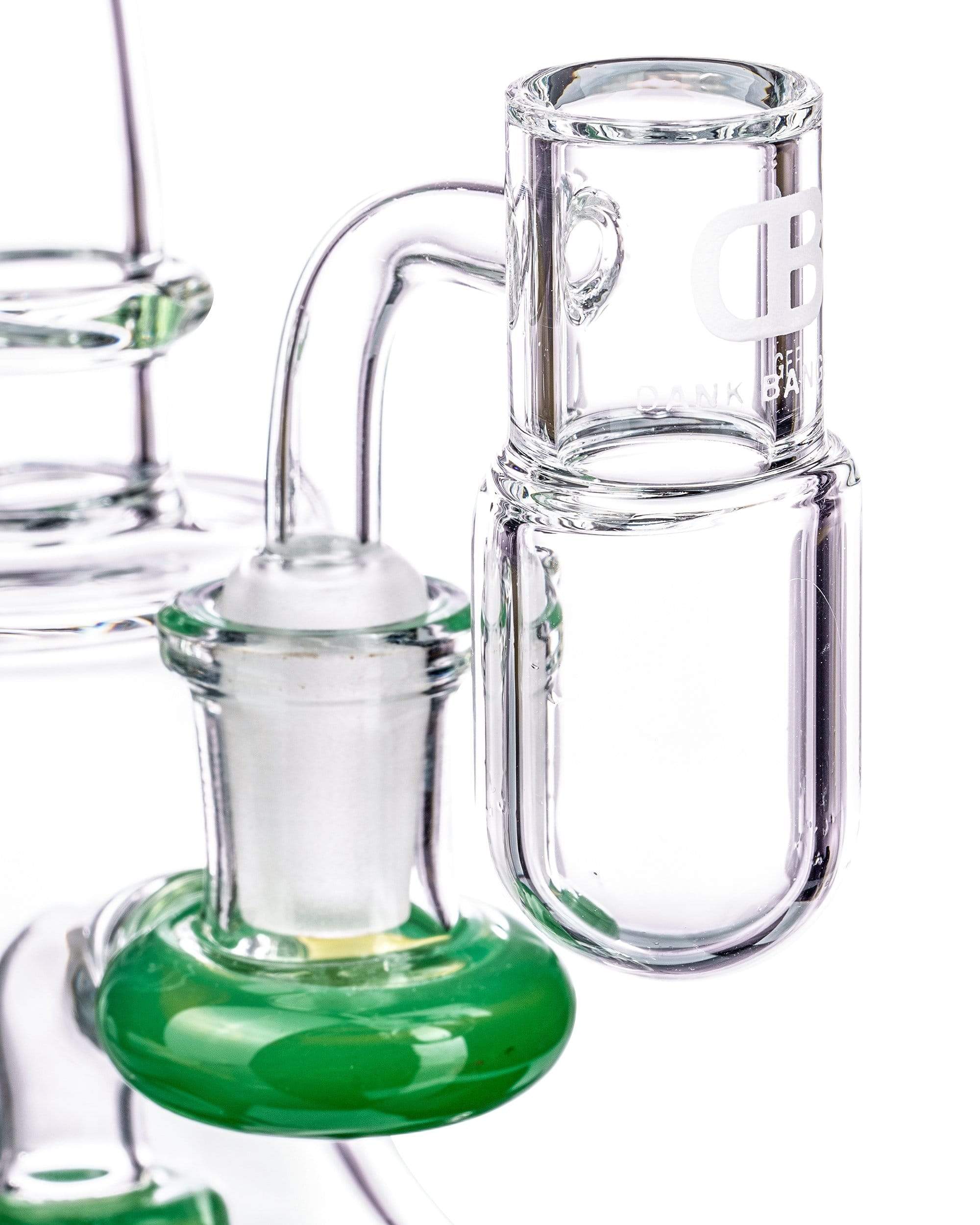 Close-up side view of clear glass tubing and a green glass base on the 1490 Round Base Splashguard Dank Banger