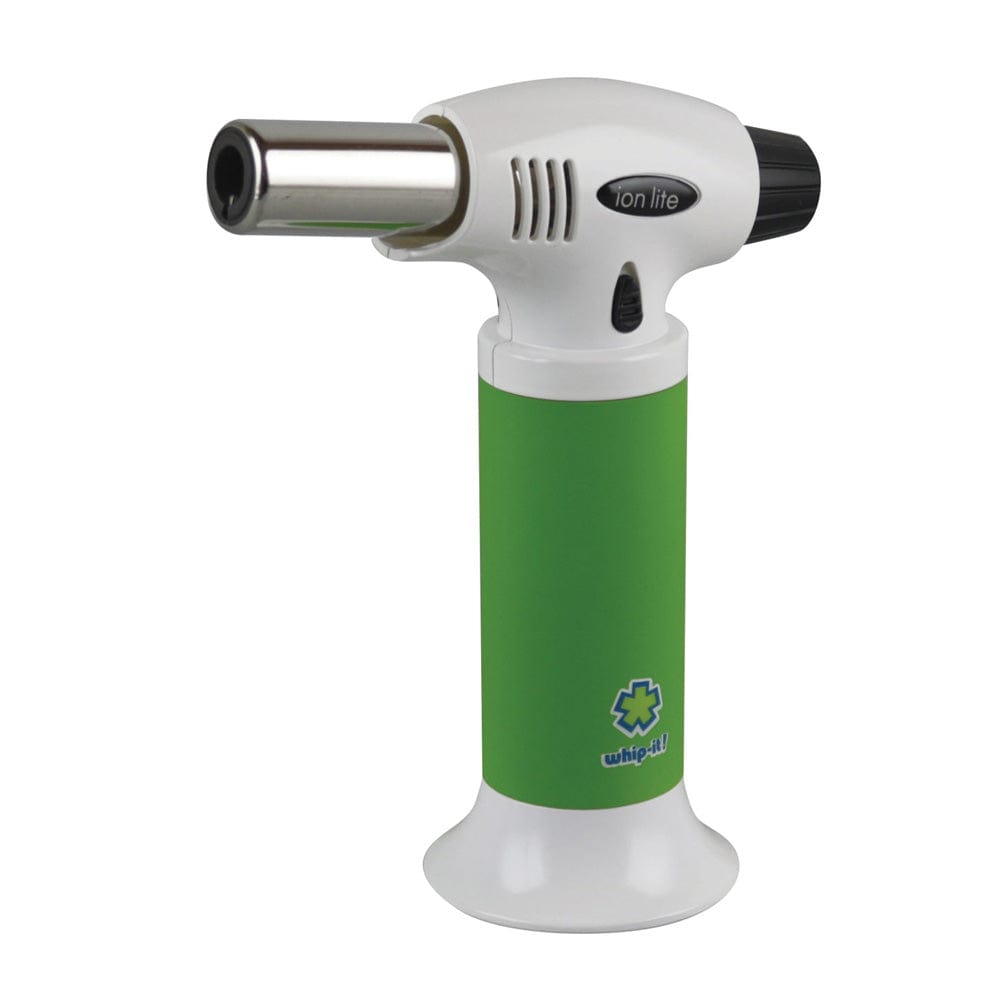 Front three-quarter view of a green-handled Whip-It! Ion Lite Torch Lighter with its white head, metal nozzle, and visible logo against a plain white background.