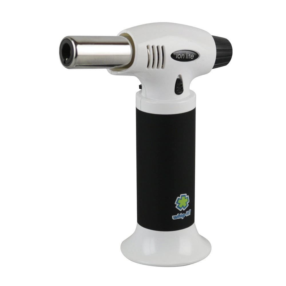 Front three-quarter view of a white and black Whip-It! Ion Lite Torch Lighter standing upright on a white background, showing its metal nozzle, vents, and brand logo on the base.