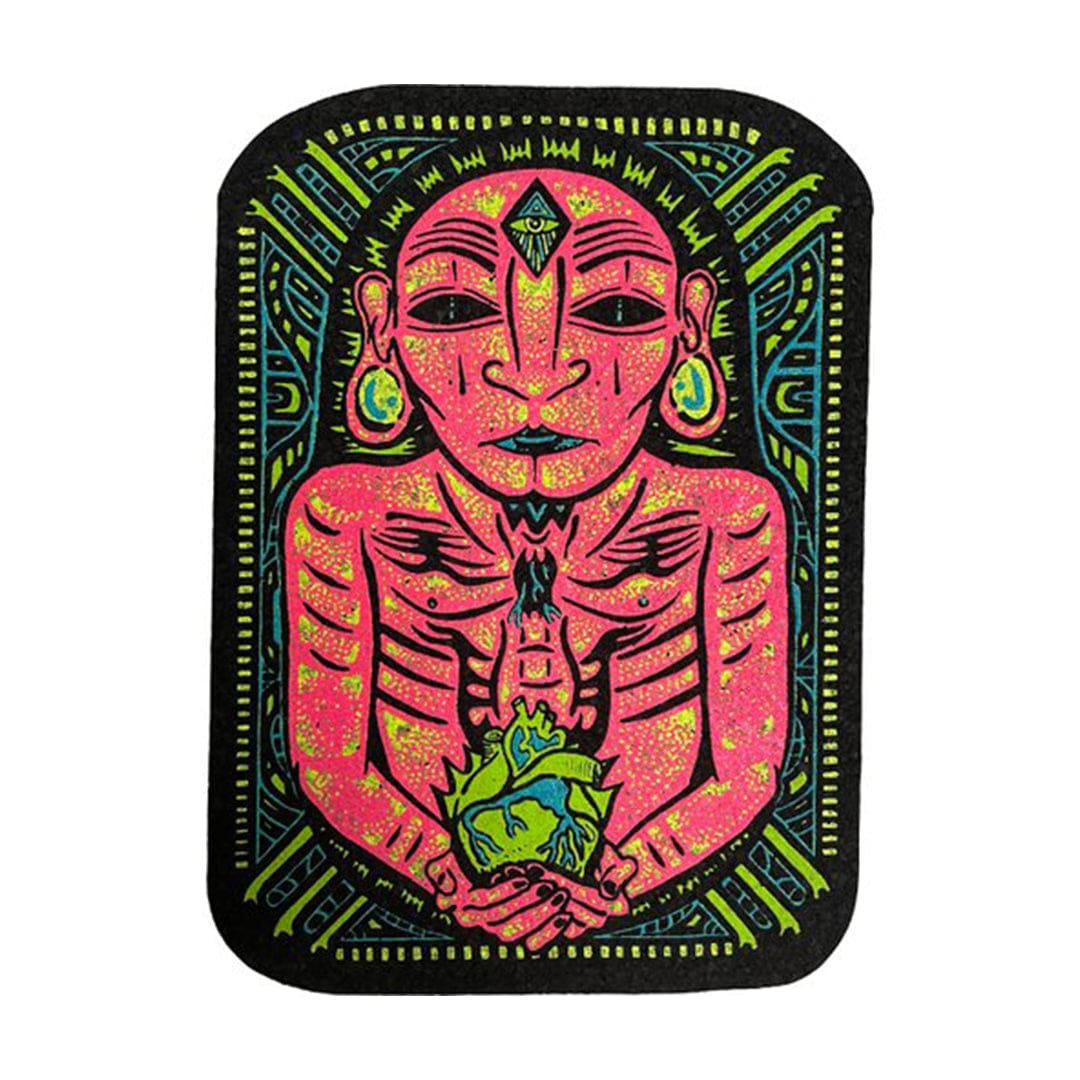 A vibrant, eye-level shot of the 10" Dab Mats featuring a colorful, patterned design resembling a face with intricate details.