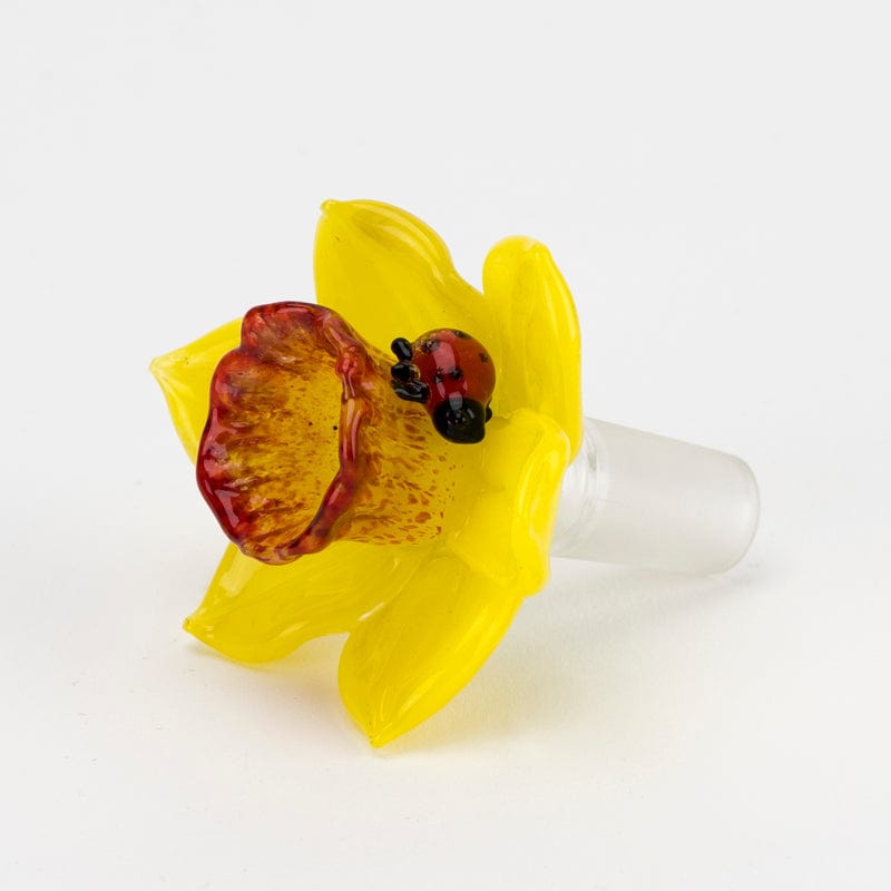 A close-up view of the Daffodil Bowl Piece, showcasing its colorful, flower-like glass form against a plain white background.