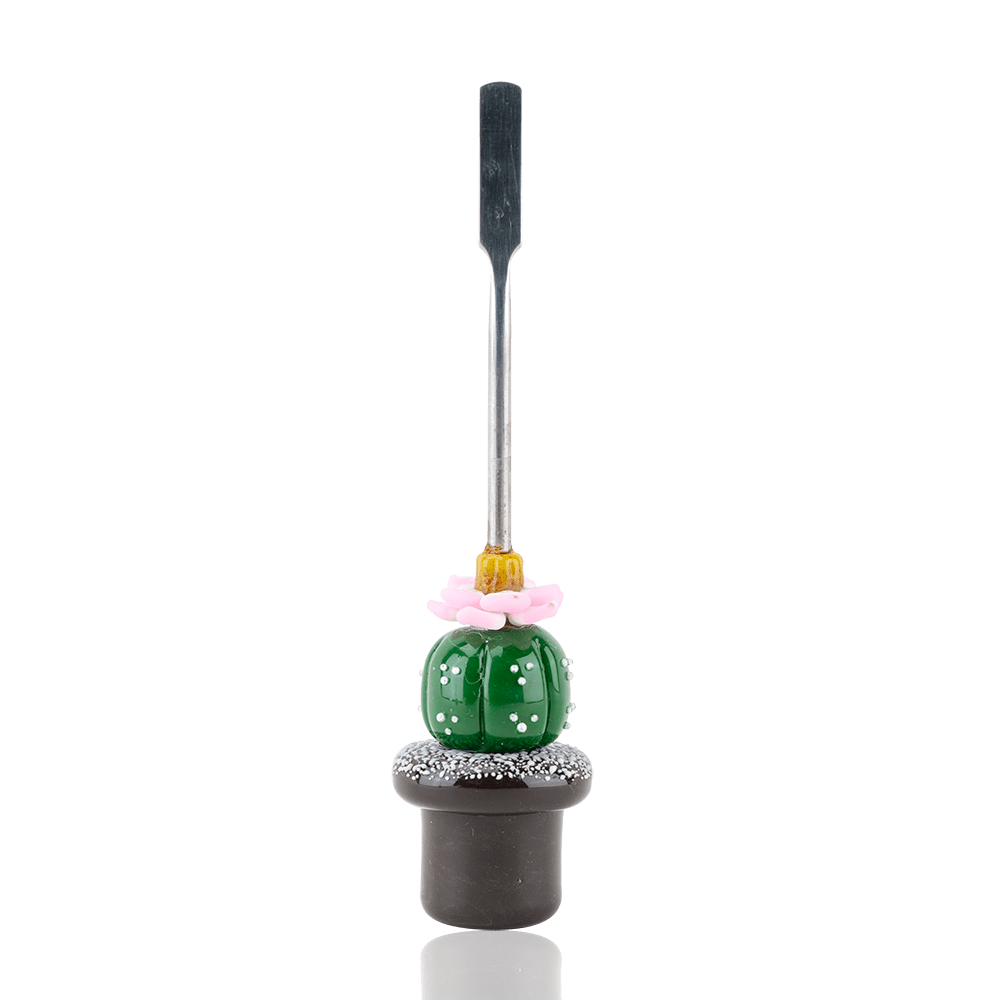 The Peyote Dabber is displayed in a close-up, angled shot, showing its sleek design and reflective surface.