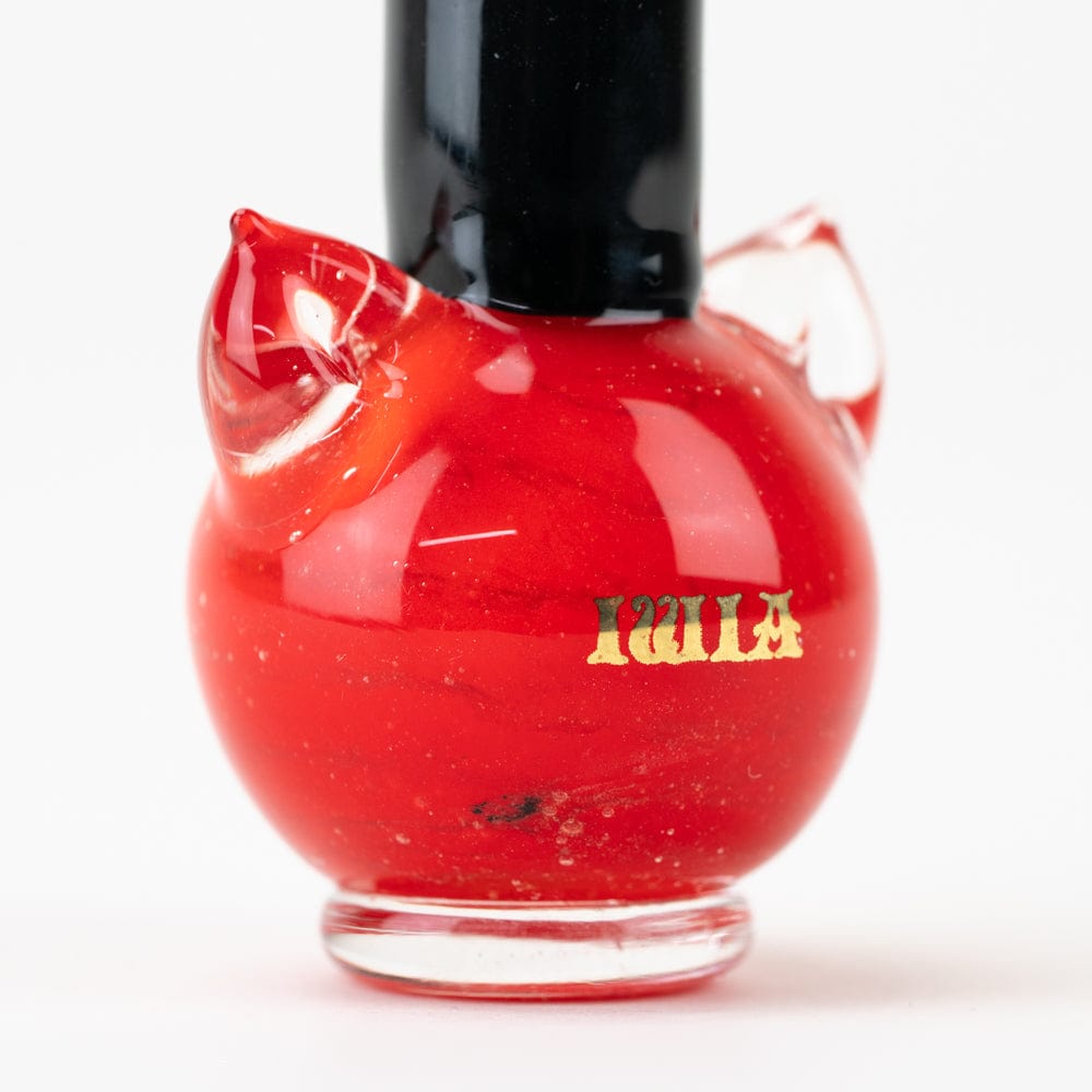 A close-up, angled view of the SakiBomb Kitty Red Nail Polish Dry Pipe, showcasing its vibrant red glass design.