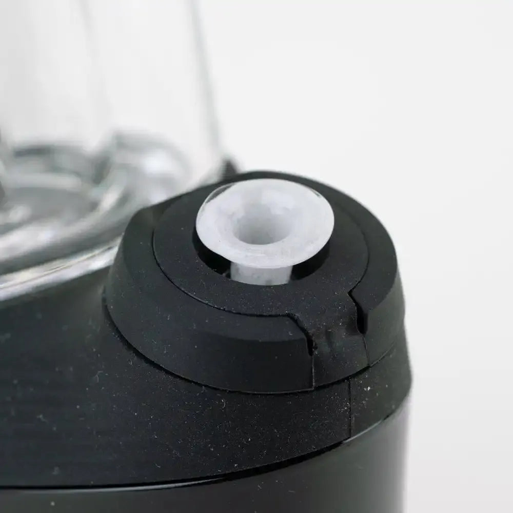Close-up angled view of the Empire Glassworks PuffCo 'New Peak' & Proxy Glass Joystick Cap - Glow in the Dark showing the white silicone joystick seated in a black cap against a soft white background