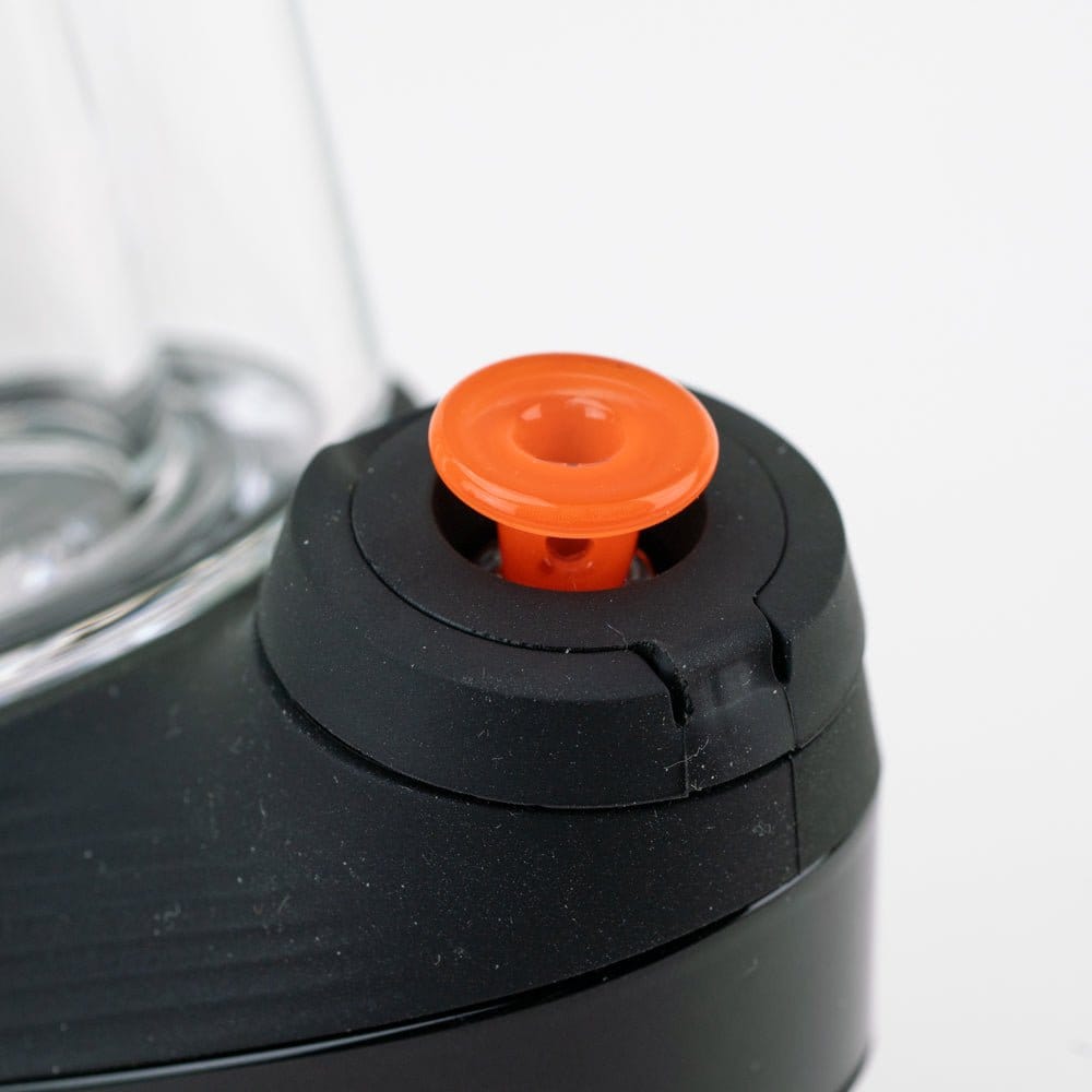 Close-up angled shot of the Empire Glassworks PuffCo 'New Peak' & Proxy Glass Joystick Cap - Orange seated in a black device collar.