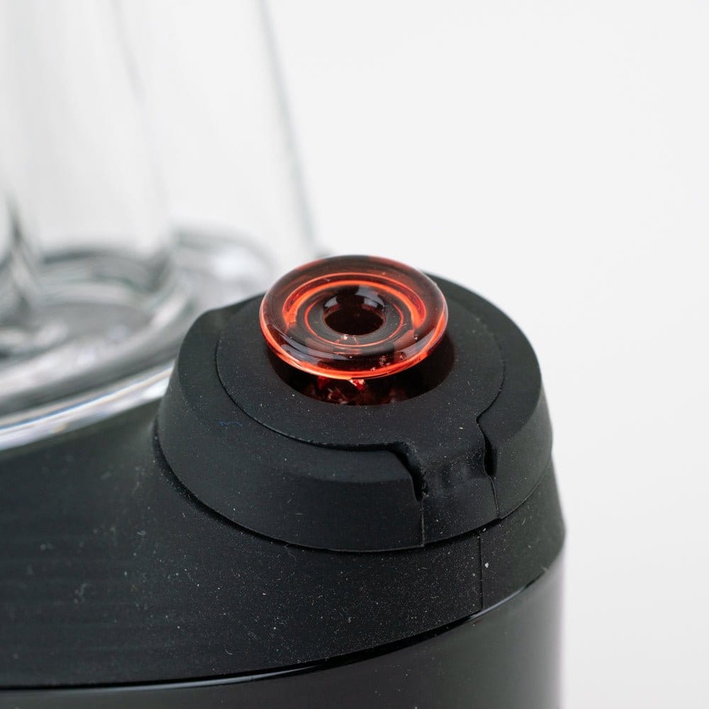 Close-up of the Empire Glassworks PuffCo 'New Peak' & Proxy Glass Joystick Cap - Translucent Red seated on a black device, shot from a slight top angle against a white background.