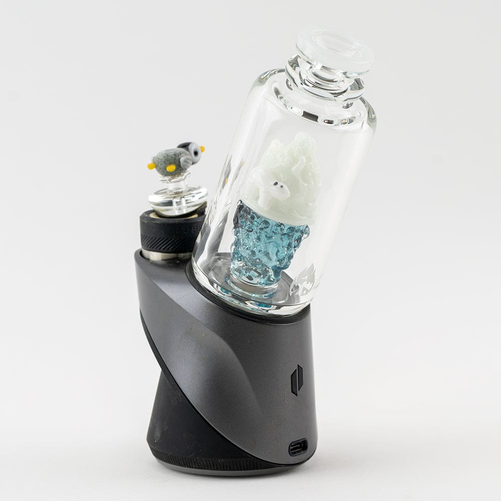 A close-up, angled view showcases the “Avenge the Arctic” Puffco Peak & Peak Pro Glass Attachment, featuring a sculpted ice bear within clear glass.