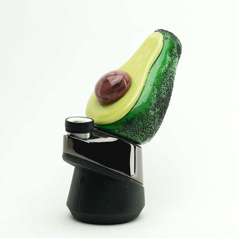 A close-up, angled view of the Avocadope PuffCo Peak & Peak Pro Glass Attachment, resembling an avocado, against a plain white background.