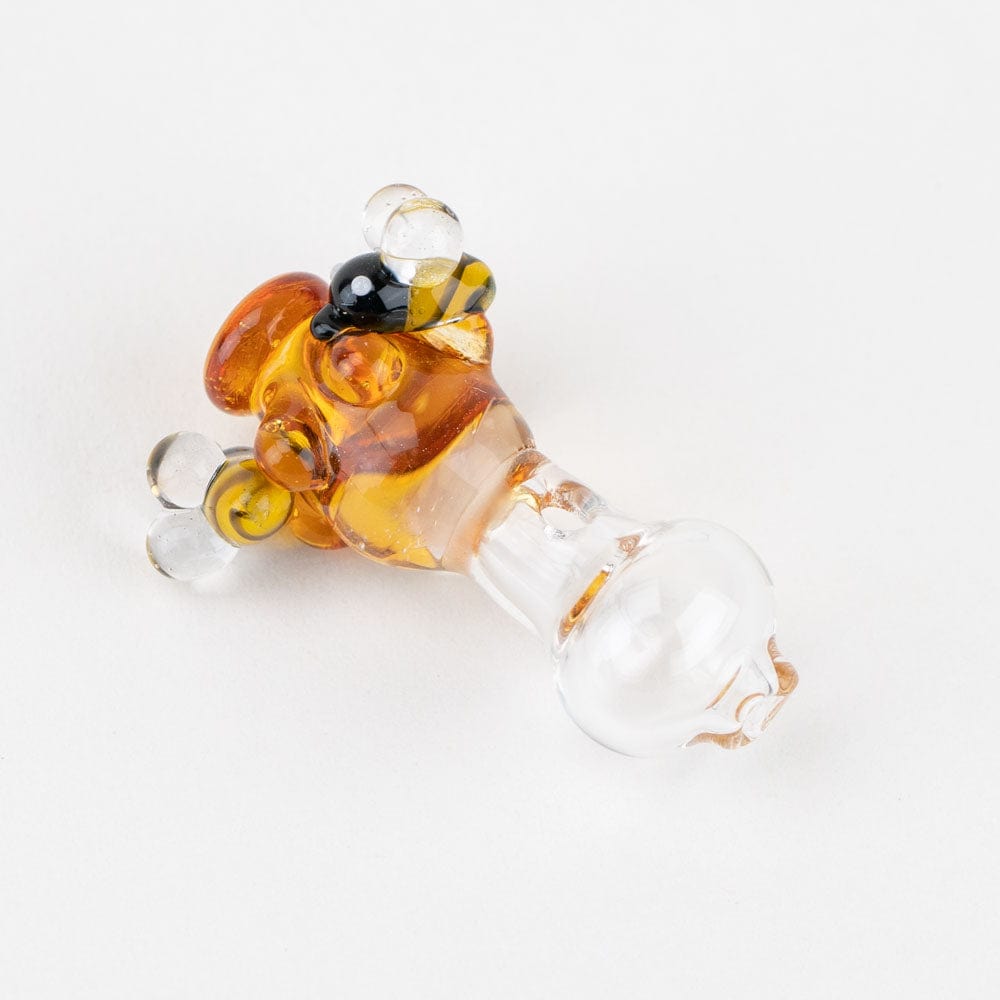 A close-up of the Beehive PuffCo Peak Pro Glass Ball Cap, showing a rounded, honey-colored glass orb.