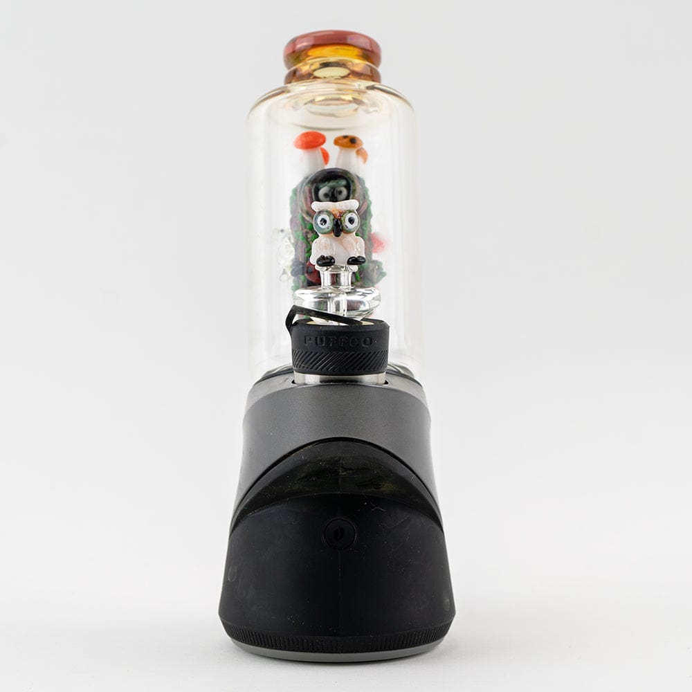 A close-up, angled view of the “Renew the Redwood” Puffco Peak & Peak Pro Glass Attachment, showing its colorful glass design.