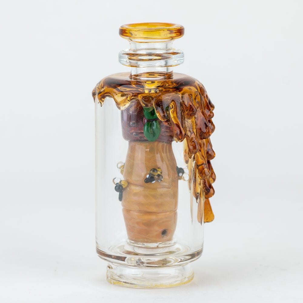 A close-up, angled view of the “Save the Bees” PuffCo Peak & Peak Pro Glass Attachment, featuring amber-colored glass with textured details.