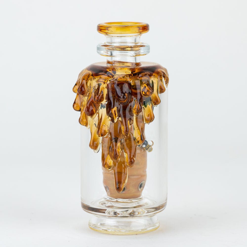 A close-up, angled view of the “Save the Bees” PuffCo Peak & Peak Pro Glass Attachment, showcasing its amber-toned, dripping design.