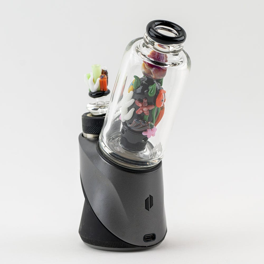 A close-up, angled view showcases the “Save the Seas” Puffco Peak & Peak Pro Glass Attachment, displaying colorful coral-like designs within the clear glass.
