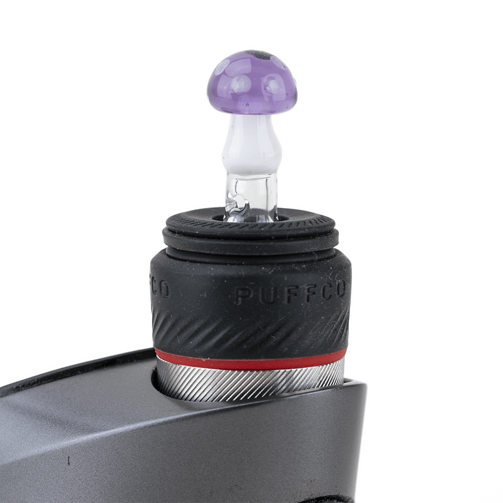 A close-up, angled view of the Sriusly Shrooms PuffCo Peak Pro glass ball cap, featuring a mushroom-shaped design.