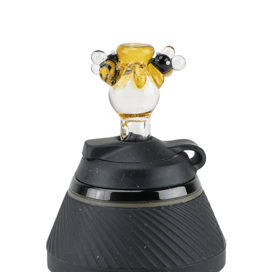 A close-up, angled view of the Beehive PuffCo Proxy Glass Ball Cap, showcasing its rounded shape and glossy finish.