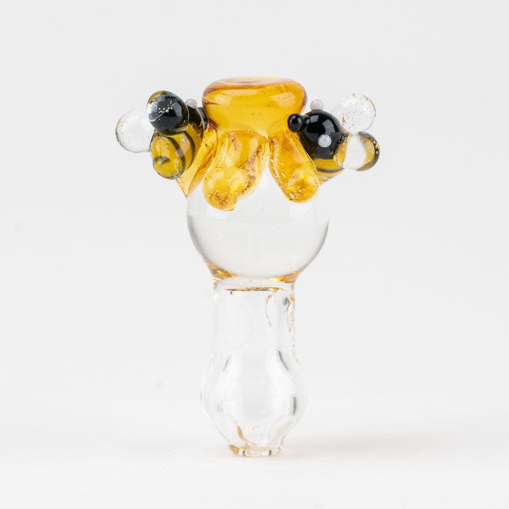 A close-up view of the Beehive PuffCo Proxy Glass Ball Cap, showcasing its textured, amber-colored glass design.