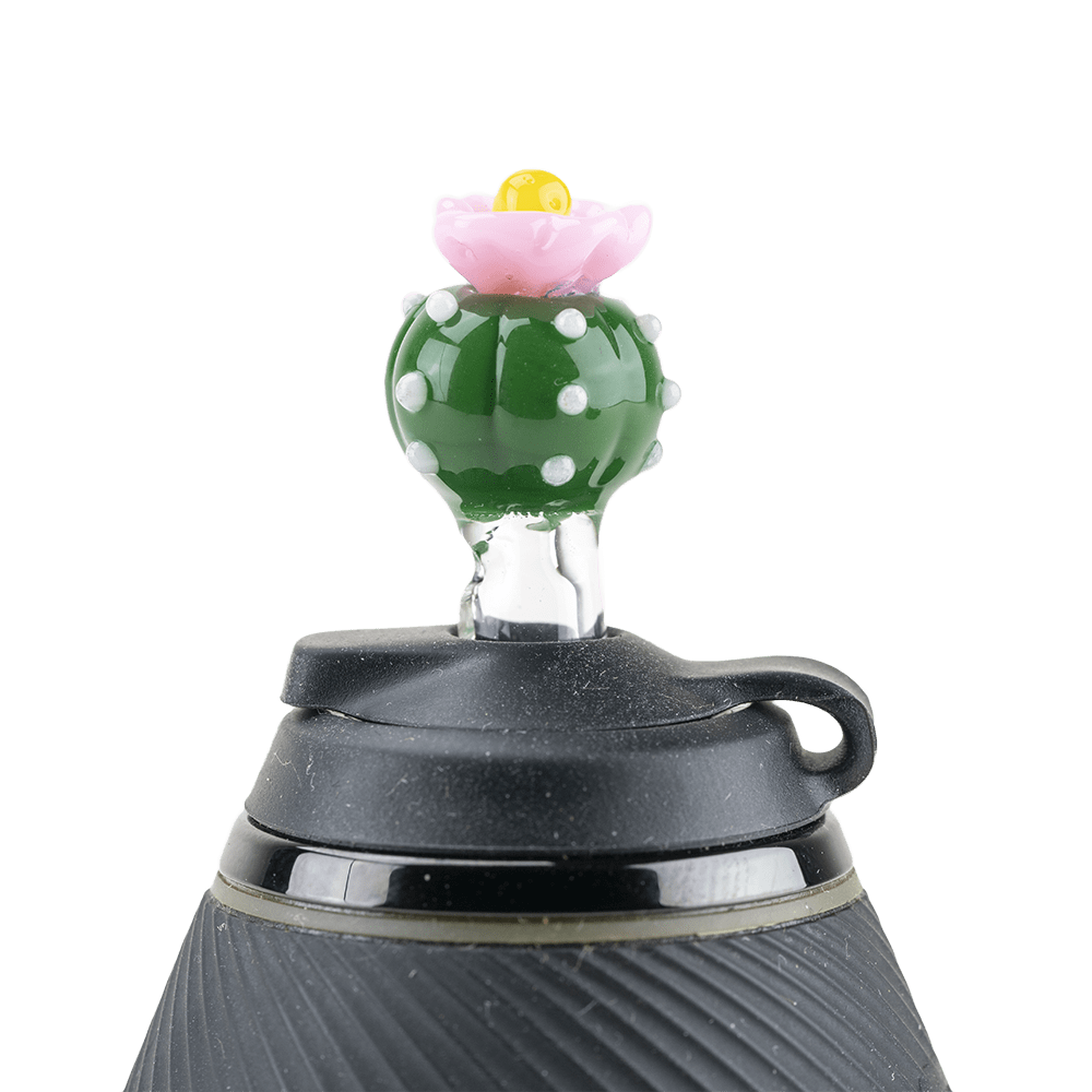A close-up, angled view of the Peyote PuffCo Proxy Glass Ball Cap, showing its clear glass construction and rounded shape.