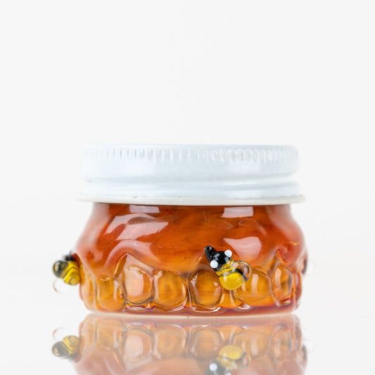 Close-up view of the Honeycomb Terp Jar, showing its clear glass construction and rounded shape.