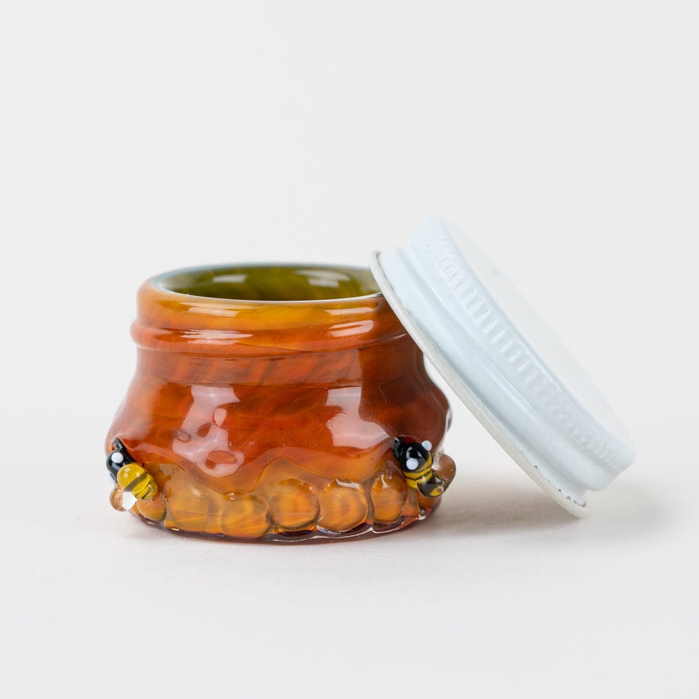 The Honeycomb Terp Jar is shown in a close-up, angled view with a clear lid slightly ajar.