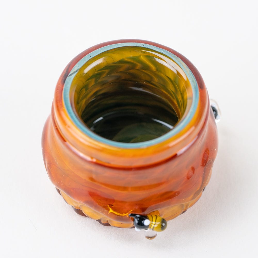 Top-down view of the Honeycomb Terp Jar, showing a translucent amber container with a dark interior and textured surface.