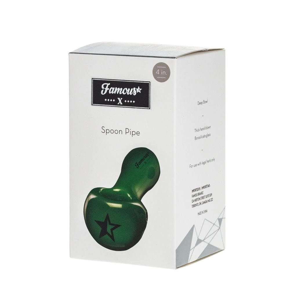 A close-up, angled view of the Famous X Milky Jade Spoon Pipe, showcasing its smooth, white and green glass construction.