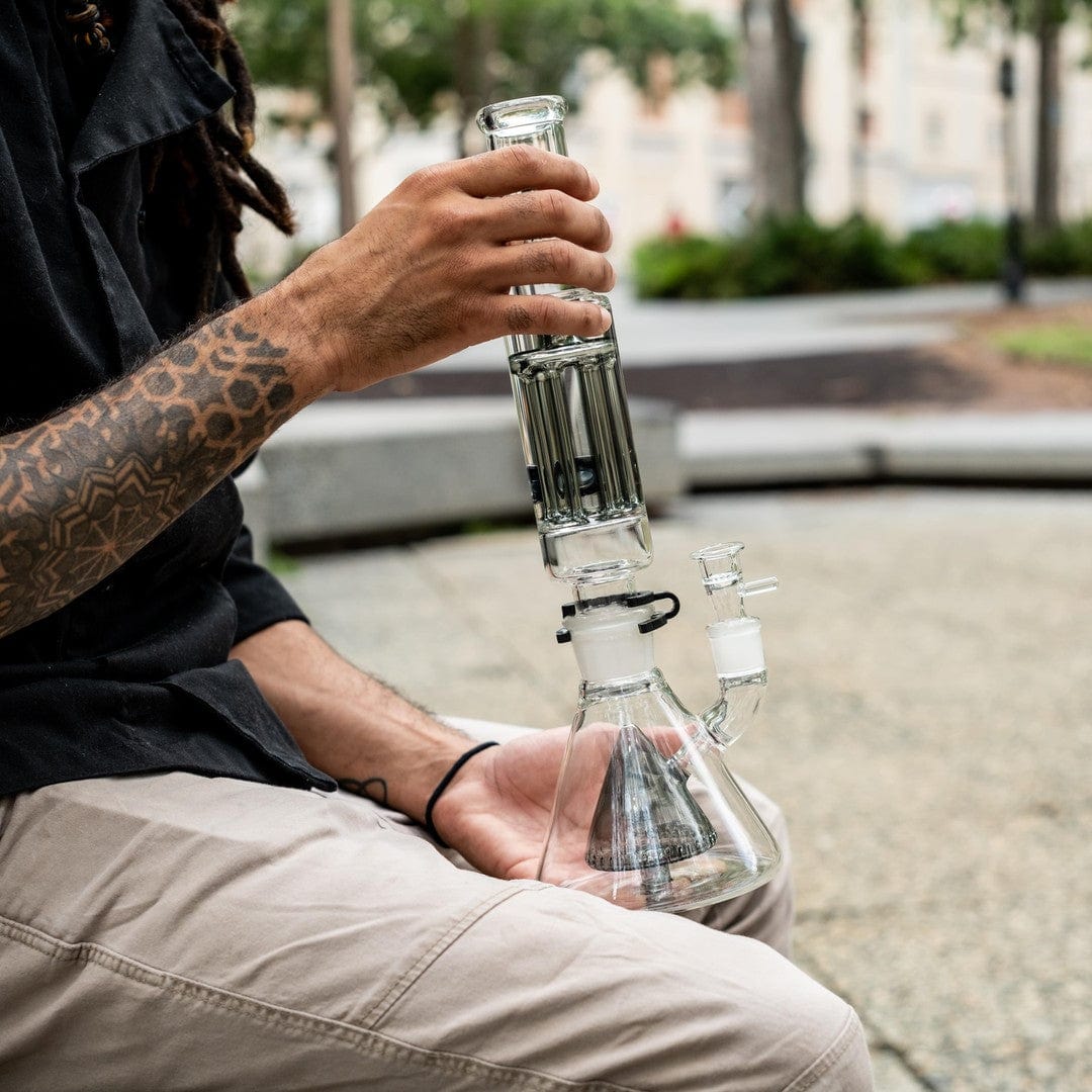 A close-up, angled view of the Freeze Pipe XL Bong held in a hand, showcasing its clear glass construction.