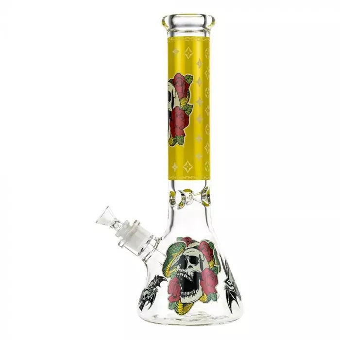 Front view of the Beaker Ice Bong with Glow in the Dark Snake and Skull Print showing a clear glass beaker base and yellow-decorated neck with skull and rose graphics.