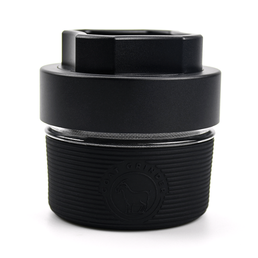 Close-up of the AITH v.I – OG Grinder Jar, showcasing its dark, textured cylindrical shape with a metallic top.
