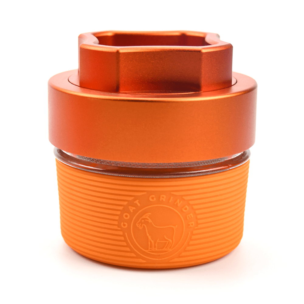 Front view of the AITH v.I – OG Grinder Jar, a cylindrical glass jar with a screw-on lid and a subtle sheen.