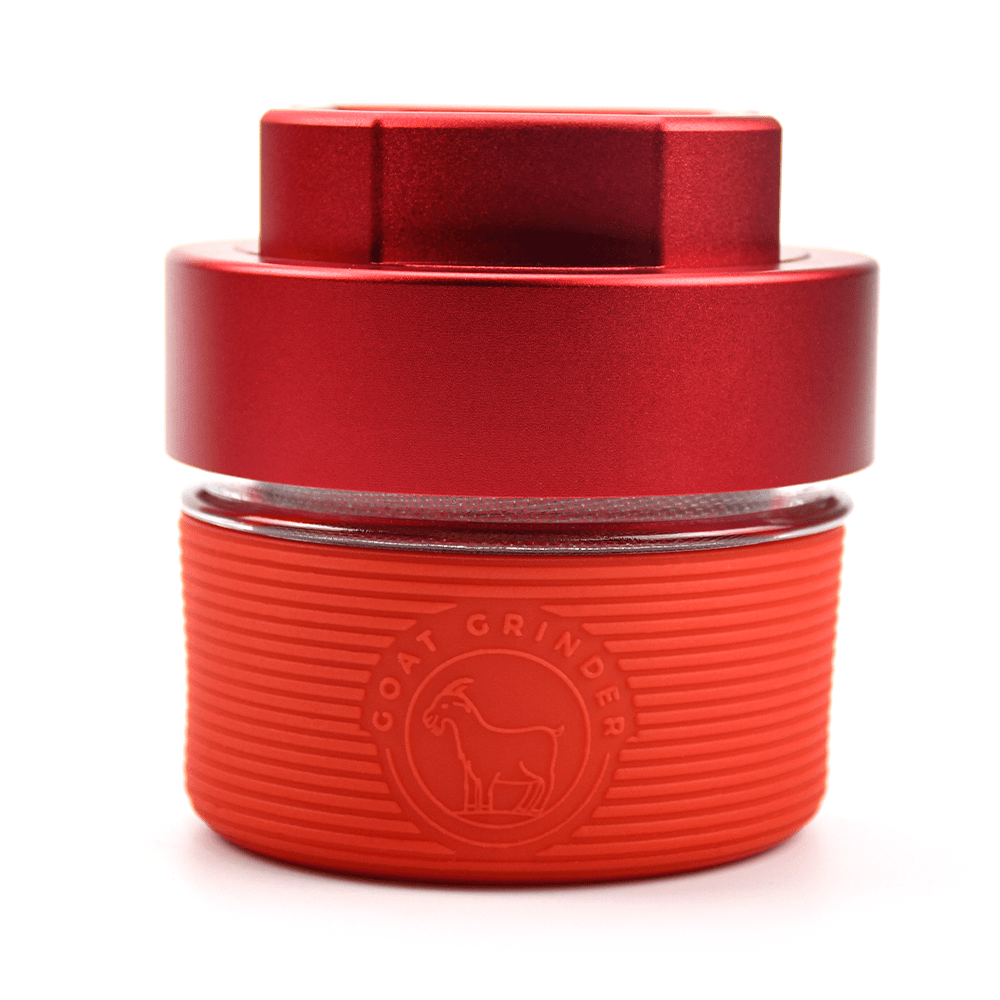 Front view of the AITH v.I – OG Grinder Jar, a red, cylindrical container with a secure screw-on lid.