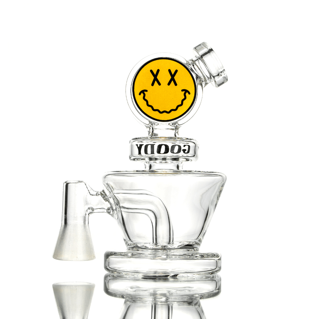 A studio shot of the Big Face VR Vape Rig, displaying its clear glass construction and unique facial feature design.