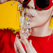 A close-up, angled view showcases the Orbit Mini Rig 4-Piece Kit, held in a hand against a red backdrop.