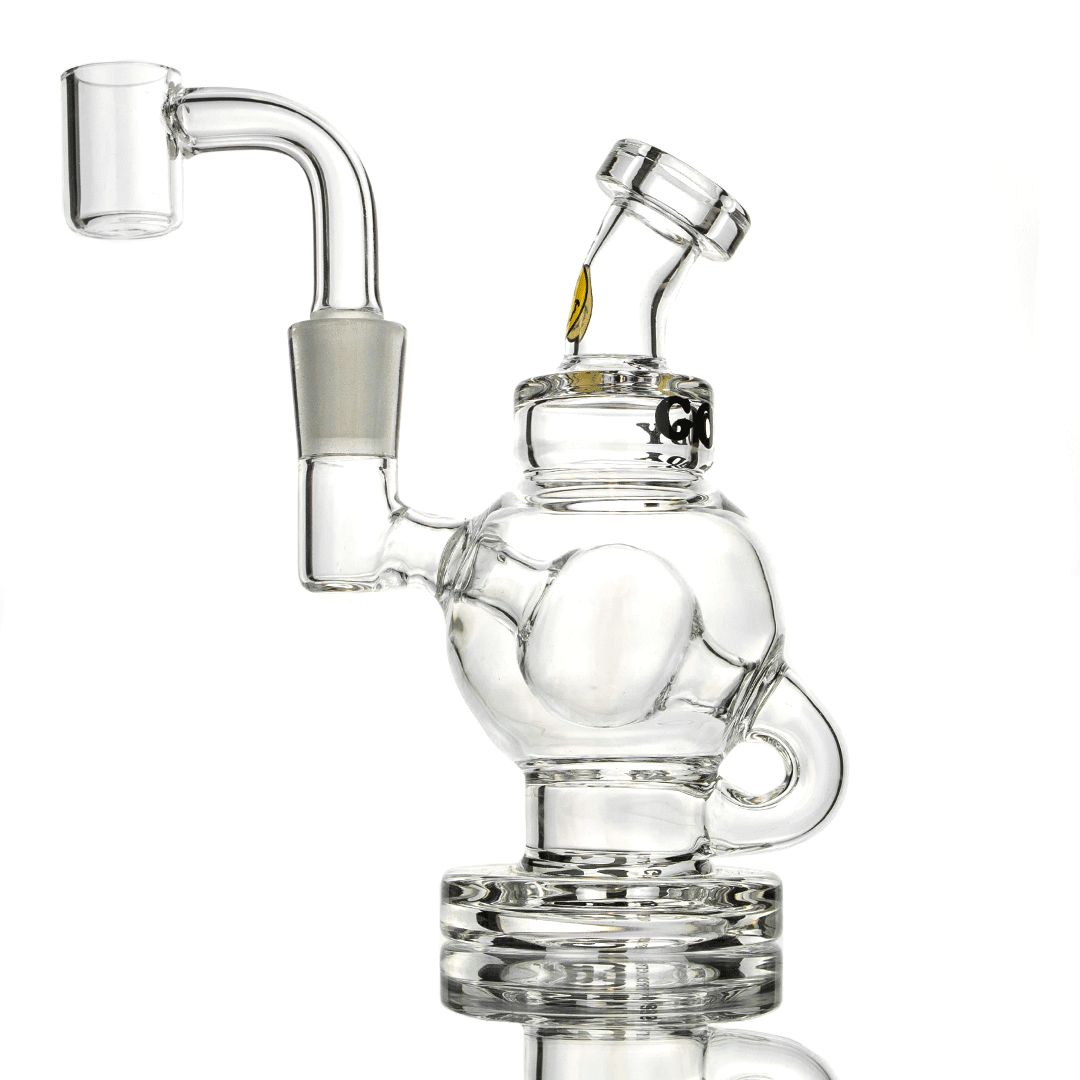 A close-up, angled view of the Orbit Mini Rig 4-Piece Kit, showcasing its clear glass construction and compact design.